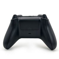 Rear view of the WR007 Xbox Wireless Controller in black, showcasing its textured grip and battery compartment for extended gaming sessions.
